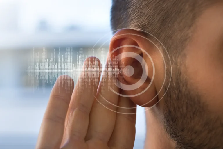 Close-up of a man’s ear with soundwave graphics and circular audio signal overlay, symbolizing hearing or sound perception.