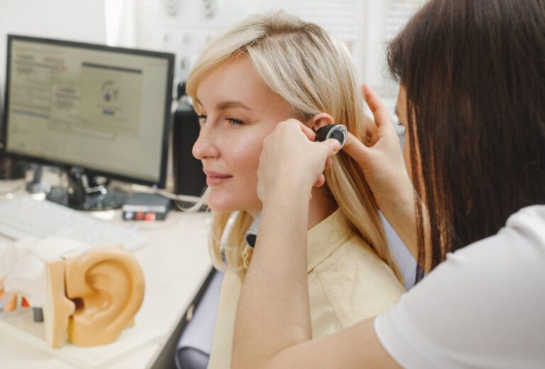 Woman patient having check-up of hearing at doctor