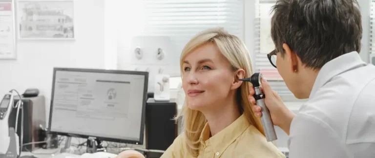 Patient inside sound booth during hearing test